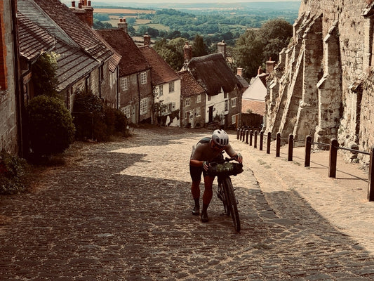 Cyclist walking up hovis hill